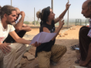 Al-Ghanem translates between Arabic and English as the school's first wall goes up. 