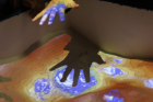 As students interact with the sand, the projected topography changes. 