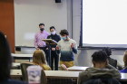 Edwin Iziharry describes his group’s idea for fixing technology, with Brenden Reilly and Liem Nguyen.
