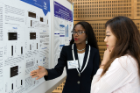 Godstime Nwatu-Ugwu (left), explains her research on aging and disease to a fellow student.
