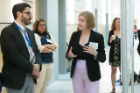 John C. Panepinto, PhD, director of the Summer Undergraduate Research Experience at UB program, listens to Cassandra Taber explain her research.