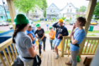 students congregate on house porch. 