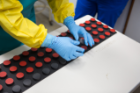 CRESE researchers are conducting experiments on how Ebola protocol garments affect a person's cognitive abilities, including decision-making and hand-eye coordination. Photo: Douglas Levere