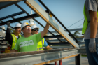 Kenneth MacKay, clinical associate professor of architecture at UB, inspects a support beam on the GRoW Home. Photo: Douglas Levere