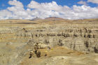 Aerial view of Liu and colleagues at the fossil locality, where she made the discovery on the Tibetan plateau. The hilly formations in the background are the Zanda Earth Forest. 