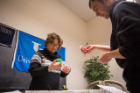 During the 2017 judging, UB Assistant Professor of Chemistry Ekin Atilla-Gokcumen examines a crystal submitted for the "Coolest Crystal" category, new that year. Credit: Meredith Forrest Kulwicki / University at Buffalo