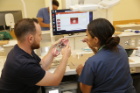 Fourth-year UB dental student Richard Salvagno (left) works with program participant Jalisa Whitehorse. Photo: Cass McAllister
