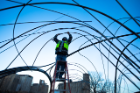 The view from the ground as a studio member connects stainless steel tubing. Photo: Douglas Levere