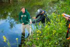 A team of Pauls! Depew High School teachers Paul Parrinello (left) and Paul Caban worked together to collect a sediment core from Bizer Creek. They got a little muddy. Credit: Douglas Levere / University at Buffalo