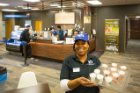 LaTasha Hemphill offers passersby Starbucks Frappuccino samples. Photo: Douglas Levere