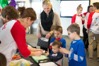 Christina Faraci (in black scarf) signs in with her sons Michael, Nicholas and Rafael.