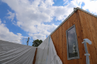 The 1,100-square-foot solar dwelling, which produces more energy than it consumes and features an in-house greenhouse where occupants can grow food year-round, will educate the public about low-energy living and provide classroom space in its new life as a university and community resource center.