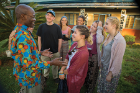 Bishop Mwita Akiri (left) founded the sewing project. Here, he talks with UB students.
