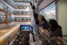 Spectators take full advantage of the grand atrium's many bird's-eye views to watch the grand opening ceremony. Photo: Meredith Forrest Kulwicki