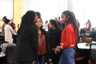Students talk with peers they don't know and tell each other why they want to study medicine.