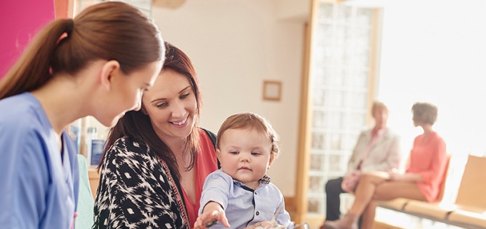 Mom and child talking with health care professional. 