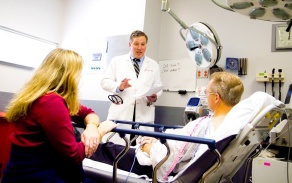 Physician talking with patient and family member. 