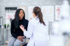 Provider talking with a woman in a medical office. 