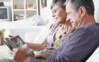 Older woman and man sitting on a couch. 