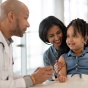 Experienced Family Medicine physician providing an annual physical check up with mother and child. Top pediatric care in Amherst, NY. Top primary care offices Tonawanda, NY. Top family medicine office in Buffalo, NY. 